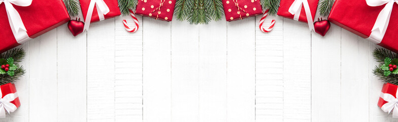 Fototapeta na wymiar Christmas gift boxes with decorating ornaments on white wood background border design