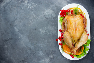Roasted whole chicken on plate with christmas decoration