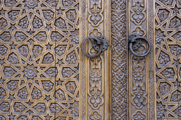 An old wood door with metal handle. Details of Muslim architecture.