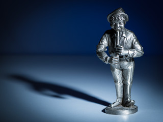 A small figurine of a flute player