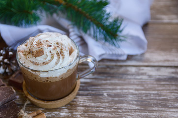 Cup of hot chocolate cocoa with whipped cream and chocolate crumbs on wooden table with  christmas ...