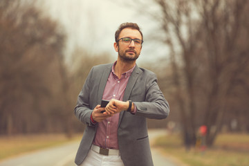 Business modern guy using cellphone outdoors.