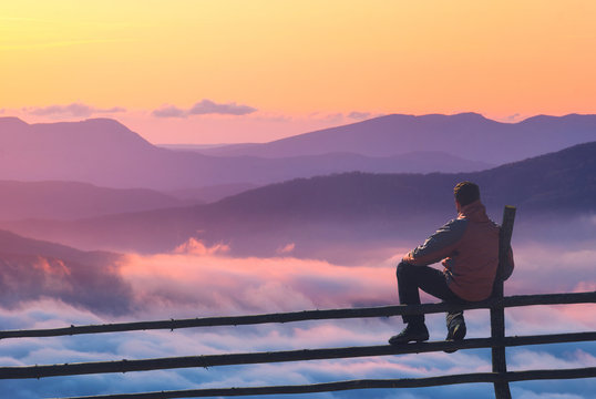 Man On A Fence Enjoying The Sunset