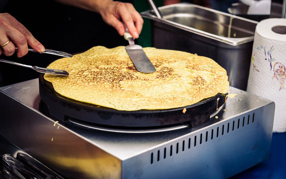 Making of crepes pancakes in open market festival fair.