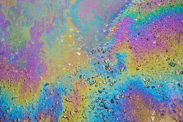 Petrol on the asphalt a big polluted puddle water.