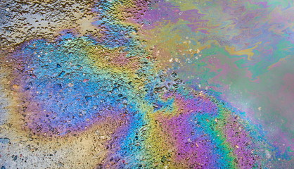 Petrol on the asphalt a big polluted puddle water.