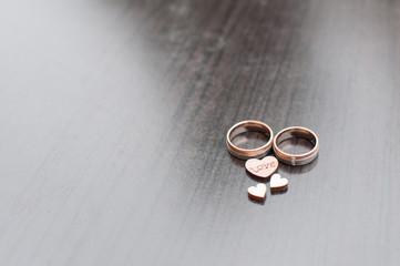 wedding rings with wooden hearts showing love
