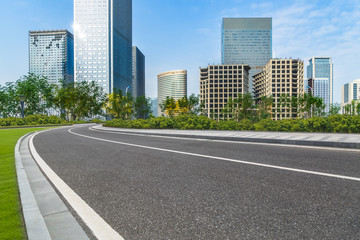 asphalt road through the modern city skyline