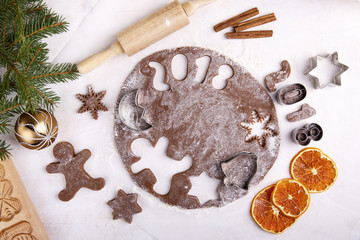 Making gingerbread cookies for Christmas Raw dough, cutters, baking ingredient