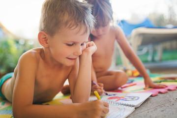 Little boy and girl drawing with crayons