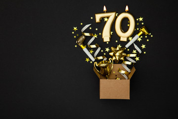 Number 70 gold celebration candle and gift box background
