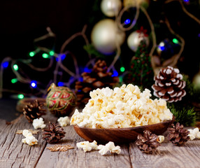 Obraz na płótnie Canvas popcorn on the background of Christmas and New Year's decorations, selective focus