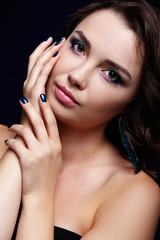 Portrait of beautiful brunette woman on black background