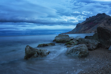 Fototapeta na wymiar Evening landscape overlooking the sea and the rocks of Karadag, Crimea