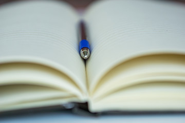 Close-up of an open blank notebook with a pencil for writing, notes, making.