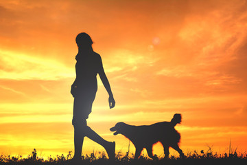 Silhouette women and dog playing at sky sunset in holiday