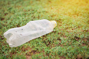 Close-up plastic garbage on green grass