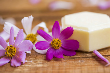 Spa setting with natural soap and flowers, wellness concept
