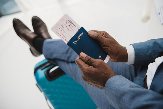 man holding passport and fly ticket