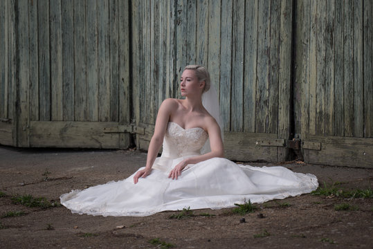 Young bride in the urban decay environment of Platt's Eyot Island in Hampshire UK