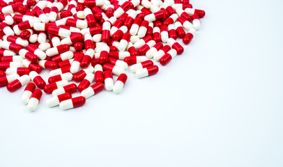 Red, white antibiotic capsules pills on white background with copy space. Drug resistance, antibiotic drug use with reasonable, health policy and health insurance concept.
