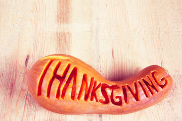 lettering word 'Thanksgiving' on a pumpkin