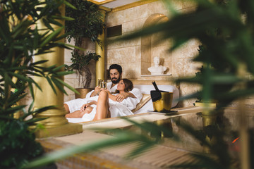 Beautiful young couple enjoying and relaxing in SPA center