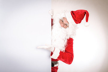 Merry christmas,Santa Claus pointing in white blank sign,Isolated on white background.