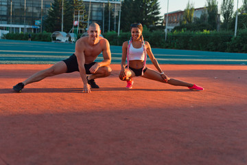 A guy and a girl at the stadium are engaged in sports, lifestyle