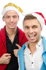 Christmas and New Year. Two attractive guys in Santa's hats. 