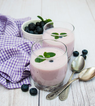 Glasses with blueberry yogurt on a table