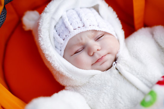 Portrait of adorable newborn baby in warm winter clothes