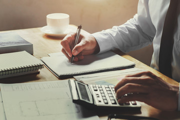 accountant working on desk office with using a calculator and pen, finance accounting concept