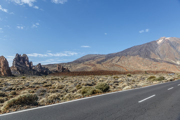 An old road crosses a wide arid and volcanic area