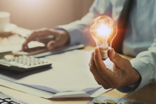 hand man accountant holding light bulb, new idea with innovation concept