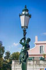Fototapeta na wymiar Interesting street lamp, sculpture woman. Details. Lisbon, Portugal