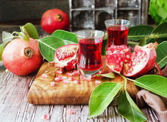 Fresh pomegranates and juice, selective focus