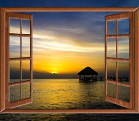 view from the open window of the caribbean sunset