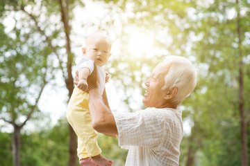 Naklejka premium Grandparent and grandchild outdoors.