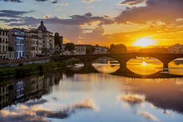 Florence cityscape view with Ponte Vecchio, a medieval stone bridge over Arno River.