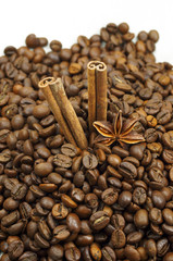 Cinnamon sticks to the right on coffee beans