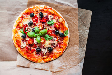 Hot pizza slice with Pepperoni, cheese, mozzarella and tomato  on a rustic background  close up. .