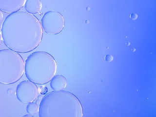 Drops of oil floating in water.