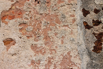 Textures of weathered stone wall background of the ancient city.