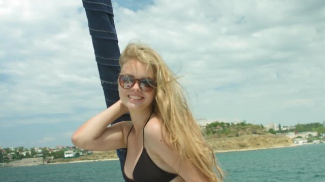 Holiday of the positive blonde on the yacht