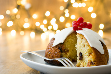 Christmas pudding and christmas light on wooden table
