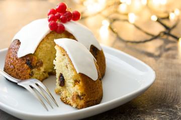 Christmas pudding and christmas light on wooden table
