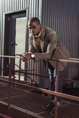 Handsome african american man leaning on guardrails