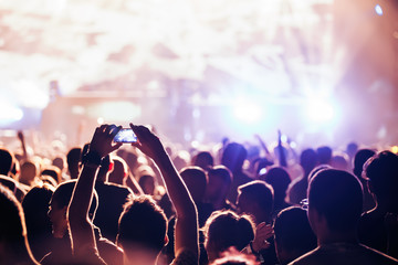 Cheering crowd with hands in air at music festival