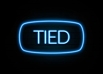 Tied  - colorful Neon Sign on brickwall